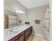 Bathroom showcasing a single sink vanity, neutral color palette, and shower with curtain at 20390 Lagente Cir, Venice, FL 34293