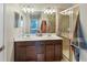 Bathroom featuring double sinks, a large mirror, and a glass-enclosed shower at 20390 Lagente Cir, Venice, FL 34293