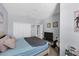 Bright bedroom featuring a closet, light gray walls, and a view of a connected room at 20390 Lagente Cir, Venice, FL 34293