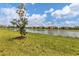 Beautiful lake view with lush lawn and multiple townhome residential buildings at 20390 Lagente Cir, Venice, FL 34293