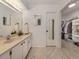 Well-lit bathroom featuring a vanity with sink and a walk-in closet at 214 Lorraine Ave, Venice, FL 34293