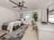 Cozy bedroom with a neutral color palette, ceiling fan, and a bright window at 214 Lorraine Ave, Venice, FL 34293