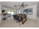 Bright dining room with a large wood table, gray chairs and views of the outdoor patio at 214 Lorraine Ave, Venice, FL 34293