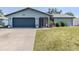 Charming one-story home featuring a two car garage, lawn, and manicured landscaping at 214 Lorraine Ave, Venice, FL 34293