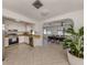 Open concept kitchen and dining room with tile flooring and bright white walls at 214 Lorraine Ave, Venice, FL 34293