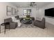 Bright living room with tile floors, gray sectional sofa, and modern décor at 214 Lorraine Ave, Venice, FL 34293