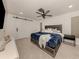 Spacious primary bedroom features neutral tile flooring, modern decor, and a ceiling fan at 214 Lorraine Ave, Venice, FL 34293