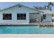 Backyard pool featuring a waterfall feature, outdoor seating, and black-trimmed pool tiling at 214 Lorraine Ave, Venice, FL 34293