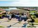 Beautiful aerial view of luxury townhomes and a community lake, showcasing lush landscaping and serene water views at 23194 Banbury Way # 202, Venice, FL 34293