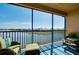 Waterfront screened lanai boasting stunning views and comfortable outdoor seating at 23194 Banbury Way # 202, Venice, FL 34293