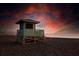 Secluded lifeguard stand on a peaceful beach against a dramatic sunset sky, evokes serenity and safety at 23194 Banbury Way # 202, Venice, FL 34293