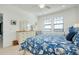 Bright bedroom featuring a dresser, two windows with blinds, and a patterned nautical-themed bedspread at 23194 Banbury Way # 202, Venice, FL 34293