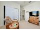 Bedroom with closet and neutral decor featuring a chair and colorful cabinet at 23194 Banbury Way # 202, Venice, FL 34293