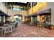 Inviting courtyard with brick pavers, outdoor seating, and charming cafe storefronts at 23194 Banbury Way # 202, Venice, FL 34293