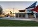 Modern building exterior featuring awning and glass doors with a view of the sunset at 23194 Banbury Way # 202, Venice, FL 34293