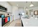 Bright kitchen featuring white cabinetry, stainless steel appliances, and a quartz countertop island at 23194 Banbury Way # 202, Venice, FL 34293