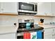 Close-up of a stylish kitchen, showcasing stainless steel appliances, white subway tile, and quartz countertops at 23194 Banbury Way # 202, Venice, FL 34293