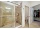 Beautiful shower features glass door and neutral-colored tile in bathroom with toilet and walk-in closet at 23194 Banbury Way # 202, Venice, FL 34293