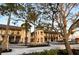 Charming street view with palm trees showcasing the upscale building facades at 23194 Banbury Way # 202, Venice, FL 34293