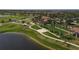 Scenic aerial view of golf course community featuring lush landscaping, lakes and beautiful homes at 24065 Canterwood Way, Venice, FL 34293