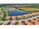 Community aerial showing neighborhood, a lake and pristine landscaping at 24065 Canterwood Way, Venice, FL 34293