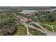 Aerial view of a neighborhood with lush landscapes, a lake, and attractive architecture at 24065 Canterwood Way, Venice, FL 34293