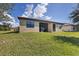 A beautifully landscaped backyard features a screened in patio and lush green lawn at 24065 Canterwood Way, Venice, FL 34293