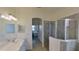 Bathroom showcasing a vanity sink, walk-in shower and a view to bedroom at 24065 Canterwood Way, Venice, FL 34293