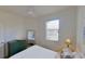 Bedroom featuring a ceiling fan, window views, and a stylish dresser at 24065 Canterwood Way, Venice, FL 34293