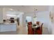 A dining room that shows the breakfast bar to the kitchen, table, and 6 chairs at 24065 Canterwood Way, Venice, FL 34293