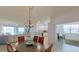 This dining area features an attractive chandelier and seamless transition to kitchen and living spaces at 24065 Canterwood Way, Venice, FL 34293