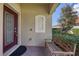 Inviting front porch features a charming bench, brick pavers, and decorative window at 24065 Canterwood Way, Venice, FL 34293