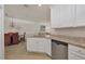 Bright, open kitchen featuring granite countertops, stainless steel appliances, and a view into the dining area at 24065 Canterwood Way, Venice, FL 34293