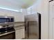 Kitchen area featuring stainless steel appliances, granite countertops, and white cabinets at 24065 Canterwood Way, Venice, FL 34293