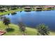 Aerial view of the tranquil lake with views of waterfront homes at 24065 Canterwood Way, Venice, FL 34293