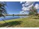 Scenic lake view showcasing the expansive water feature and surrounding green space of the property at 24065 Canterwood Way, Venice, FL 34293