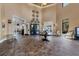 Welcoming lobby with high ceilings, elegant furnishings, and double doors to the Palm Dining area at 24065 Canterwood Way, Venice, FL 34293