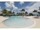 Community pool with lounge chairs and umbrellas, featuring a shallow wading area perfect for relaxation at 24065 Canterwood Way, Venice, FL 34293