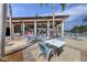 Poolside dining area with outdoor seating, offering a relaxing space to enjoy meals and refreshments at 24065 Canterwood Way, Venice, FL 34293