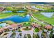 Aerial view of community featuring golf course, lakes, residential area and clubhouse at 24229 Spartina Dr, Venice, FL 34293