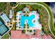 Aerial view of community pool and tennis courts surrounded by lush landscaping and residential buildings at 24229 Spartina Dr, Venice, FL 34293