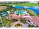 Aerial view of clubhouse, pools, tennis courts, with lake and golf course in the background at 24229 Spartina Dr, Venice, FL 34293