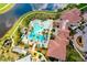 A top-down view of the community's resort style pool, clubhouse, patio, and verdant landscaping at 24229 Spartina Dr, Venice, FL 34293