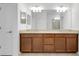 Bathroom featuring a double sink vanity with granite countertop, large mirror and modern lighting fixtures at 24229 Spartina Dr, Venice, FL 34293