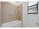 Bathroom featuring a tiled shower-tub combination at 24229 Spartina Dr, Venice, FL 34293