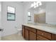 Bathroom featuring a granite-topped vanity, cabinets, and tile flooring at 24229 Spartina Dr, Venice, FL 34293