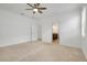 Neutral bedroom showcases a peek into an ensuite bathroom for added convenience at 24229 Spartina Dr, Venice, FL 34293