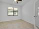 This bedroom provides a tranquil space with a tile floor and natural light at 24229 Spartina Dr, Venice, FL 34293