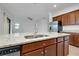 Kitchen island with granite countertops, stainless steel appliances, and wooden cabinetry at 24229 Spartina Dr, Venice, FL 34293