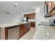 Kitchen island featuring a stainless steel dishwasher, granite countertop, and cabinetry at 24229 Spartina Dr, Venice, FL 34293